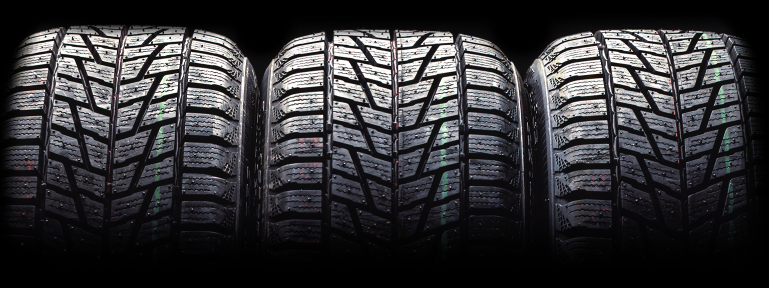 Three stacked winter tires close-up.
