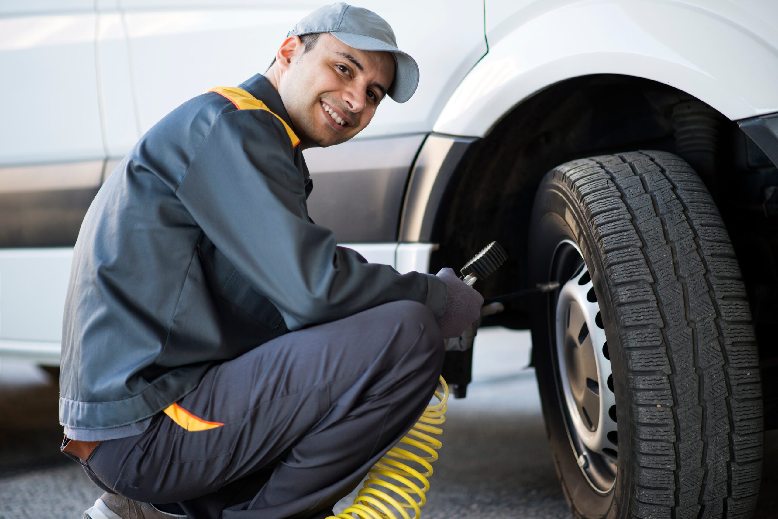 Mechanic inflating car tire.